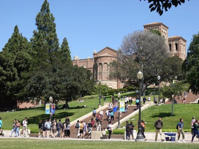 Students walk up and down an outdoor staircase.