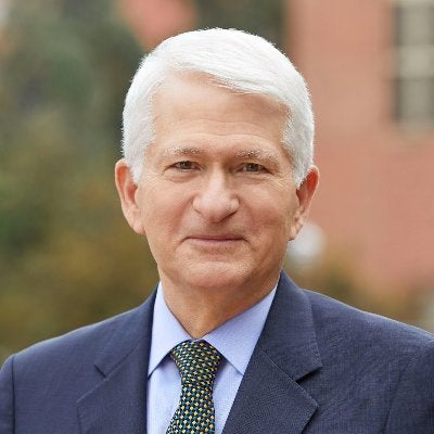 Chancellor Block, a man with short silver hair, smiles for a portrait.