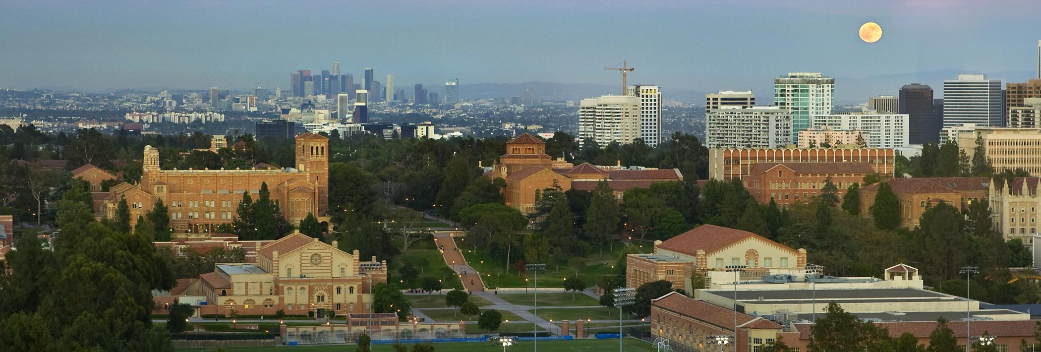 An aerial view of UCLA campus underneath a sunset and full moon.
