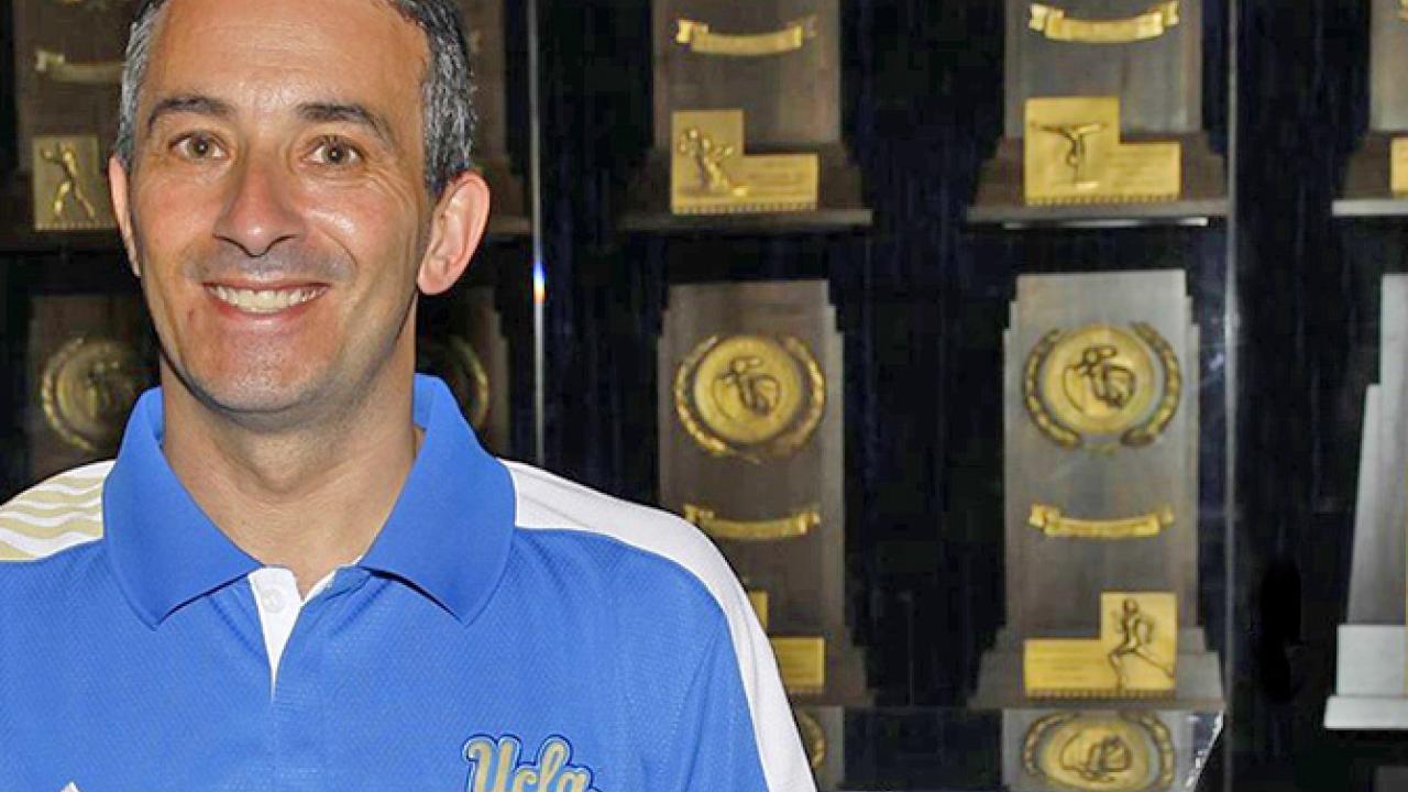 Josh Lewin, a man with short dark hair wearing a UCLA polo.
