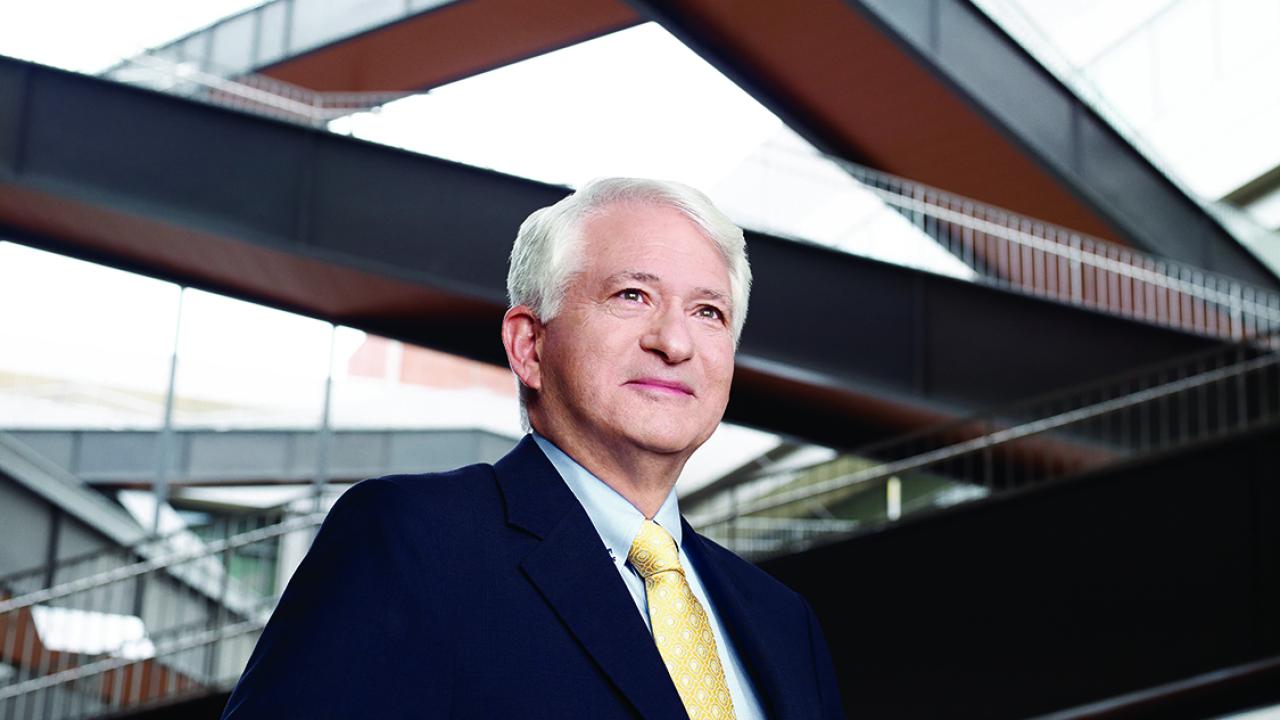UCLA Chancellor Gene Block, a man with silver hair, in a black jacket and yellow tie.