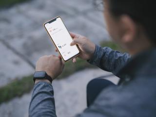 Person looks at health tracker data on their cellphone.